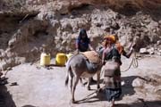 People are going for water, which is retrieving by men-chain from 20m deep wellp. Singing well in Dublock. South, Ethiopia.