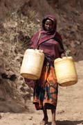 People are going for water, which is retrieving by men-chain from 20m deep wellp, Singing well in Dublock. South, Ethiopia.
