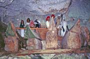 Old graves at cave. Tau tau figures and ship=shaped cofins. Tana Toraja area. Indonesia.