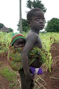 Children from Somba tribe (also called Betamarib people). Older child must take care of younger siblings. Boukoumb area. Benin.